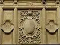 Écu ovale avec le blason de la ville de Metz avec les deux quadrilobes indiquant les dates