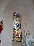 L'Assomption de Marie. Vitrail de Louis-Victor Gesta à l'église Notre-Dame-de-l'Assomption de Sost.