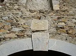 Deux pierres sculptés sont placés au-dessus du portail d'entrée : un chrisme, et un cœur avec des inscriptions en latin ou grec ? et la date de 1776