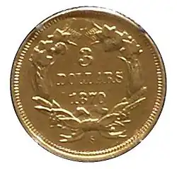 Une pièce de monnaie dorée comprenant une couronne de feuilles à l'intérieur de laquelle se trouvent les inscriptions 3 DOLLARS ET 1870.