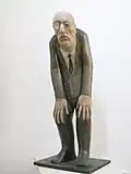 Banquier au monocle (vers 1980), bois, 105&nbsp;cm, collection particulière non sourcée.