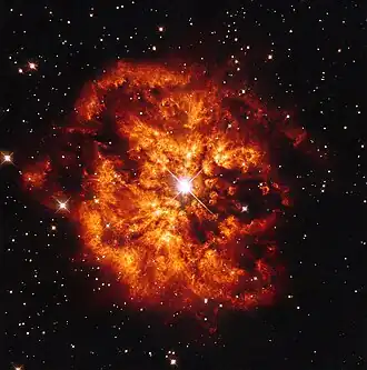 Vue d'artiste d'une étoile très brillante au coeur d'une explosion gigantesque de gaz et de poussières