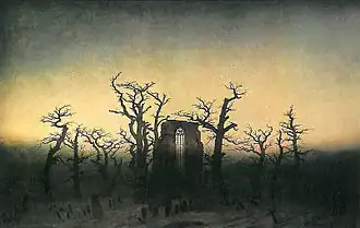 Pan de mur avec fenêtre en ogive, entouré d'arbres morts, dressé au milieu de pierres tombales