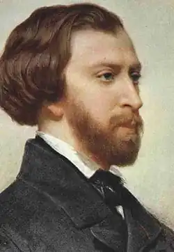 Portrait du profil droit d'un homme barbu à l’habit noir.