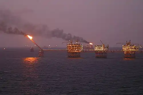 alignement de plate-formes pétrolières, l'une d'elles active une torchère.