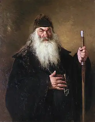 Portrait d'un diacre barbu et bourru.