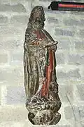 Photographie d’une statue de saint Luc rédigeant l’évangile, en bois sculpté du XVIIe&nbsp;siècle.