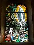 L'apparition de la Vierge à Bernadette Soubirous.