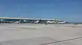 Piste de l'aéroport et avions en stationnement devant le terminal 1.