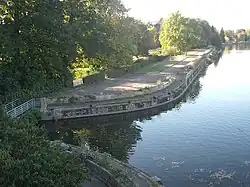 Vue du chemin parallèle à l'Allier, séparé par un mur en béton, confluent avec le Sarmon au premier plan
