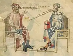 Dessin de deux hommes assis face à face, l'un vêtu de rouge tient un livre bleu, l'autre vêtu de bleu tient un livre rouge ; deux lignes de texte semblent sortir de la bouche de chacun d'eux.