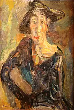 Figure féminine de face, au visage allongé, coiffée d'un chapeau sans forme et vêtue d'une robe sombre mal ajustée