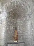 Chapelle de la Vierge Marie. Au centre, une statue de la Vierge à l'Enfant, Marie présente l'Enfant Jésus qui montre son Sacré-Cœur.