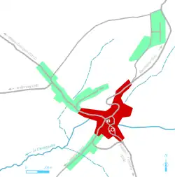 Vue d'une carte en couleur représentant les étapes de développement du bâti d'un bourg.
