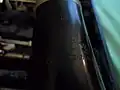 Voici un gros plan de l'emblème "American Professional" gravé sur le pavillon. Si vous regardez juste au-dessus de l'inscription "American Professional", il y a un "C" à l'envers et les lettres "LP". Cela signifie que cette clarinette est une clarinette "Low Pitched"  dans la tonalité en "do". En d'autres termes, il s'agit d'une clarinette en do fabriquée selon le diapason la3=440 Hz qui est devenu depuis la norme pour tous les instruments occidentaux.