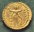 Oesho à quatre bras à trois faces avec des attributs, souvent identifiés avec Shiva, sur une pièce de Huvishka.