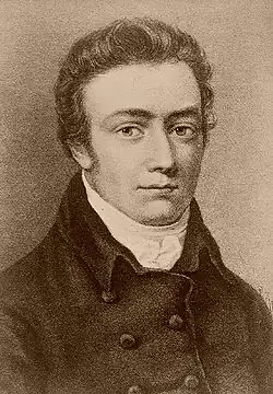 Photo noir et blanc d'un portrait en buste. Homme au visage rond et quelque peu bouffi.