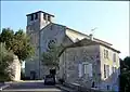 Vue sur une maison et la façade de la collégiale.
