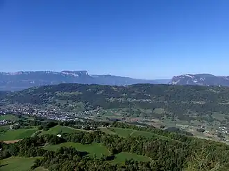 Vue depuis le pic de l'Huile à l'est de la Rochette dans le val Gelon dominé par le Montraillant avec en arrière plan le massif de la Chartreuse avec notamment le mont Granier à gauche séparé du massif des Bauges à droite par la trouée des Marches.