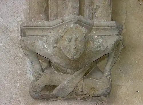 Console d'une des travées de la galerie est de l'abbaye d'Abondance, représentant un petit acrobate souriant, XIVe&nbsp;siècle.