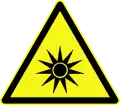 Avertissement sur les rayons lumineux, symbole D-W009 introduit par la norme allemande DIN 4844-2