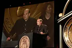 Photo de David Simon donnant un discours derrière un pupitre.