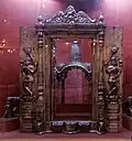 Porte d'un temple et son encadrement, accompagné d'une canopée métallique pour un sanctuaire.