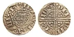 Photographie d'une pièce. Sur l'avers figure un visage peu reconnaissable entouré d'inscriptions illisibles et le revers porte une croix.