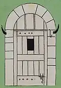 Porte de cave voûtée avec ses cornes de boucher.