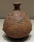 Bouteille, H. 20&nbsp;cm, terre cuite polie, peinte en rouge et incisée. Jōmon Récent, 2&nbsp;500-1&nbsp;000. Tōhoku, Nord Honshū. Met.