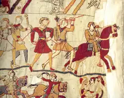Détail d'une tapisserie montrant des hommes à pied et des cavaliers.