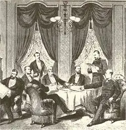 Dessin noir et blanc montrant des civils et des militaires, certains assis, d'autres debout, autour d'une table, examinant et discutant les documents objets du traité.