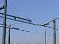 Exemple de transition entre fil de contact fixe et profil aérien de contact sur un pont escamotable