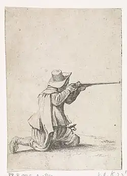 Soldat à genoux visant au fusil.