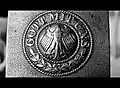 Inscription sur le fermoir d’une ceinture d’un uniforme d’après-guerre.