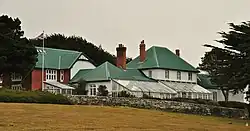 Grande maison avec des murs de pierre et une serre