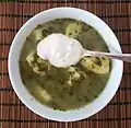 Soupe à l'oseille avec épinards et pommes de terre, recouverte de smetana.