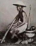 Marchand avec une pipe à opium, 1870-1880.