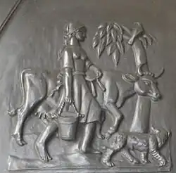 Scène de traite sur une portede la cathédrale de Guildford