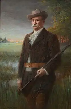 Henry Vasnier est représenté debout, un fusil à la main, devant un marais. Au loin, la gare, le village de Prunay et le fort de Nogent apparaissent.