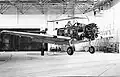 North American T-6G en train d'être déplacé dans le hangar où il est en cours de révision à Ambérieu.