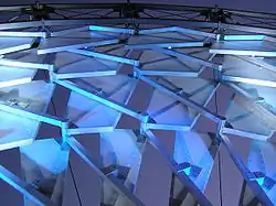 Photographie d'un détail d'une structure métallique vue de nuit.