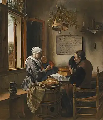 Un homme, une femme et un enfant à une table près d'une fenêtre.