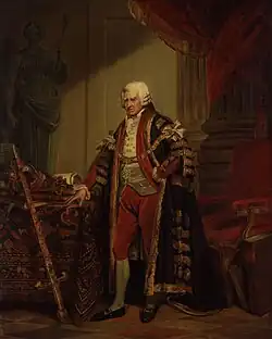 Peinture en couleurs. Homme en pied portant une perruque et des vêtements de dignitaire : une grande robe noire bordée d'or est attachée sur la poitrine d'une chaîne en or. Au premier plan à gauche, une épée posée contre un meuble sur lequel sont disposés des livres et une couronne. A droite de la figure et en arrière-plan, un meuble recouvert de velours rouge et des colonnes parées de draps rouges.