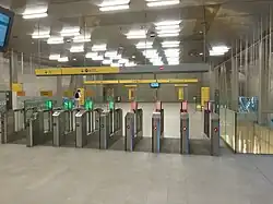 Portillons de la station Jules Ferry. Le portillon élargi est situé sur la gauche.