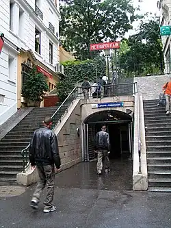 La rue vue depuis la rue Lamarck, avec l'entrée de la station de métro.