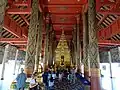 Intérieur du Wihan principal, ouvert de tous côtés, avec ses piliers décorés  de lai kham, des motifs dorés sur laque noire