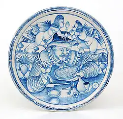 Plat peint d'un "Mangeur de macaronis", majolique de Laterza, dernier quart du XVIIe&nbsp;siècle.