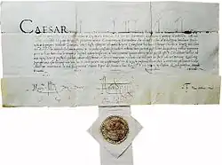 Photo d'un courrier manuscrit au bas duquel est fixé un sceau en cire.