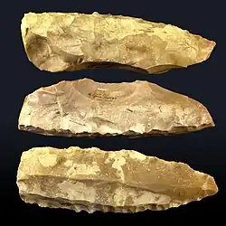 Photographie en couleurs de trois silex taillés.